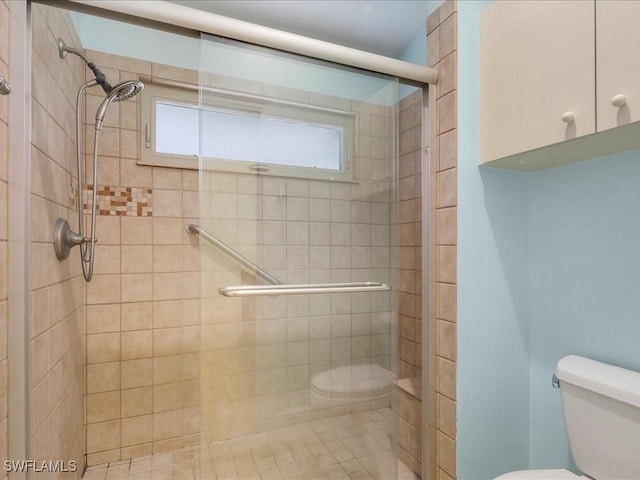 full bath with a stall shower and toilet