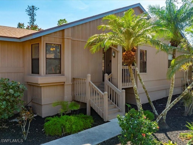 exterior space with roof with shingles