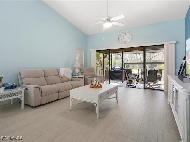 living room with high vaulted ceiling, light wood-type flooring, a sunroom, and a ceiling fan