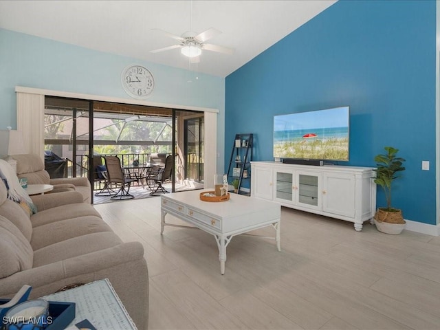 living area featuring a sunroom, high vaulted ceiling, light wood finished floors, and a ceiling fan