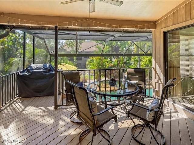 sunroom featuring ceiling fan