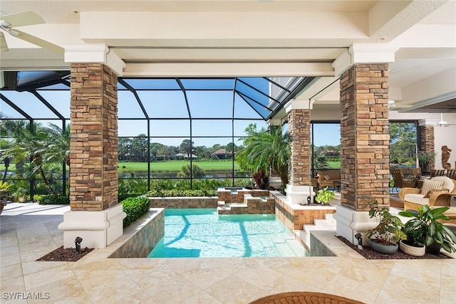 view of pool featuring glass enclosure, a patio area, and a pool with connected hot tub