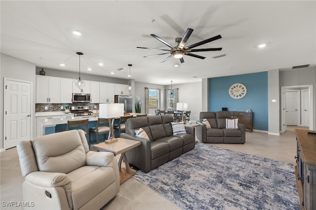 living room with light tile patterned flooring, visible vents, recessed lighting, and a ceiling fan