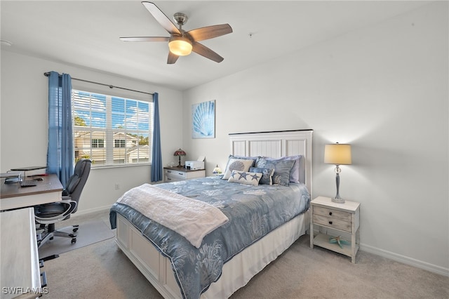 bedroom with light carpet, ceiling fan, and baseboards