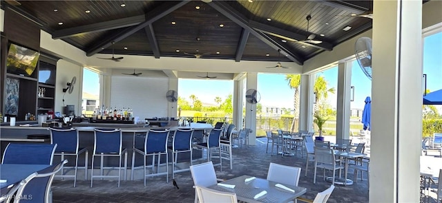 view of patio / terrace featuring outdoor wet bar, a gazebo, outdoor dining area, and ceiling fan