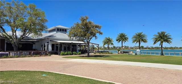 view of community with a water view and a lawn