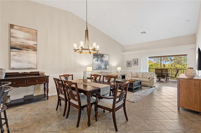 tiled dining area with a chandelier, visible vents, and high vaulted ceiling