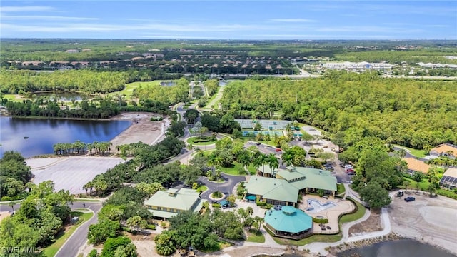 aerial view with a forest view and a water view