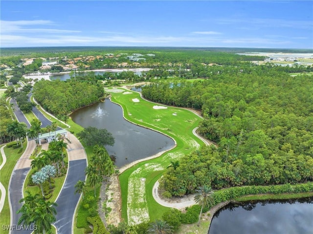 birds eye view of property with golf course view, a forest view, and a water view