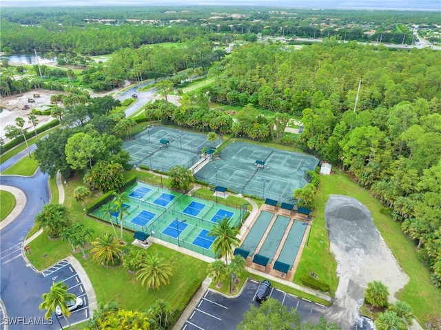 aerial view with a wooded view and a water view