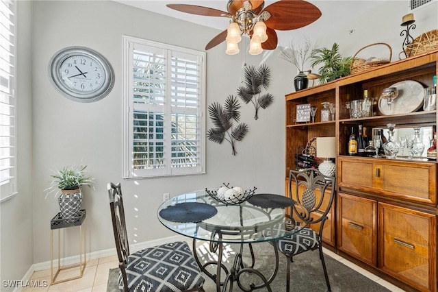 dining space featuring light tile patterned floors, visible vents, baseboards, and a ceiling fan