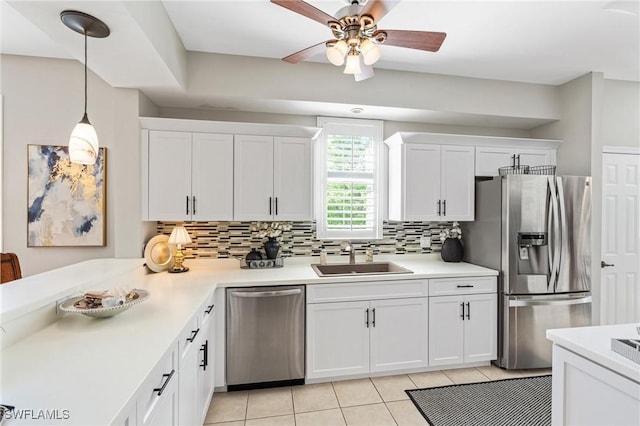 kitchen featuring a sink, light countertops, white cabinets, appliances with stainless steel finishes, and tasteful backsplash