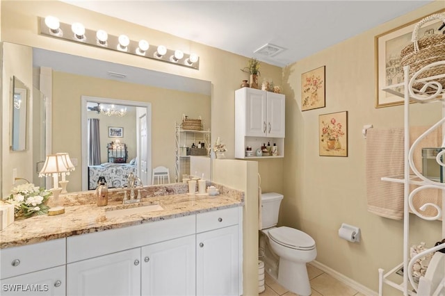 bathroom with tile patterned floors, visible vents, toilet, baseboards, and vanity