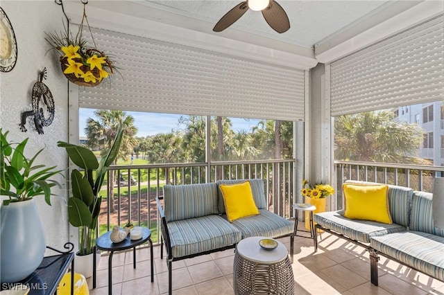 sunroom / solarium with a ceiling fan