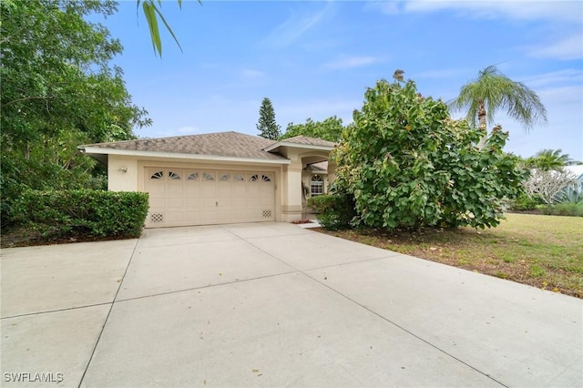 view of front of home featuring concrete driveway, an attached garage, and stucco siding