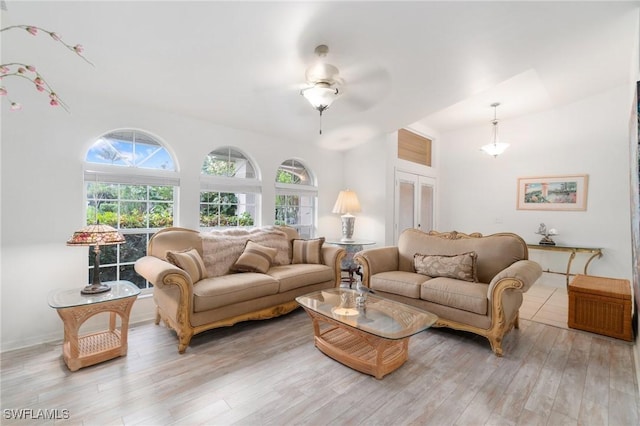 living area featuring light wood finished floors and ceiling fan