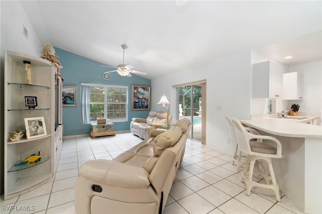 living room with visible vents, vaulted ceiling, a ceiling fan, and light tile patterned flooring