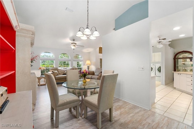 dining space featuring light wood finished floors, visible vents, washer and clothes dryer, and ceiling fan with notable chandelier