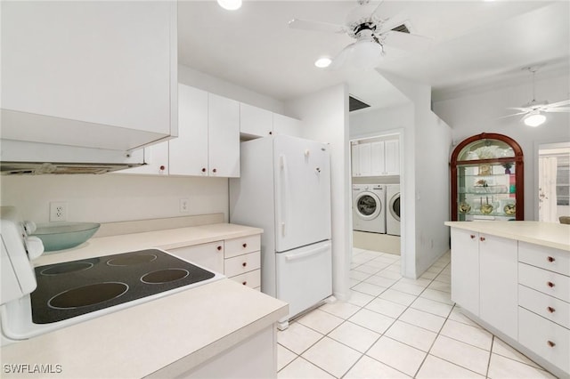 kitchen featuring a ceiling fan, white cabinets, light countertops, freestanding refrigerator, and washing machine and clothes dryer