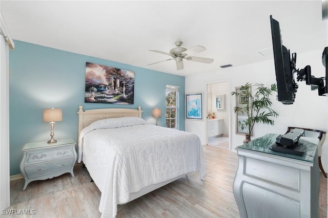 bedroom with a ceiling fan, ensuite bath, visible vents, and light wood-style floors