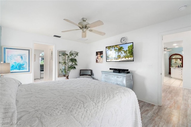 bedroom with a ceiling fan, light wood-type flooring, and visible vents