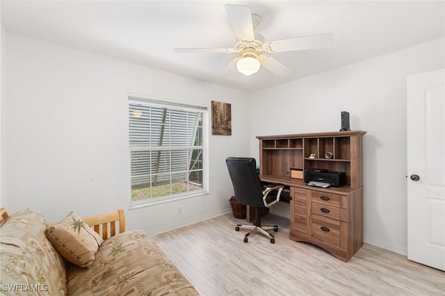 home office with light wood-type flooring, ceiling fan, and baseboards