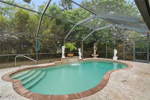 pool with glass enclosure and a patio area