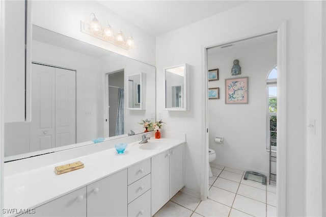 full bathroom with toilet, tile patterned flooring, and vanity