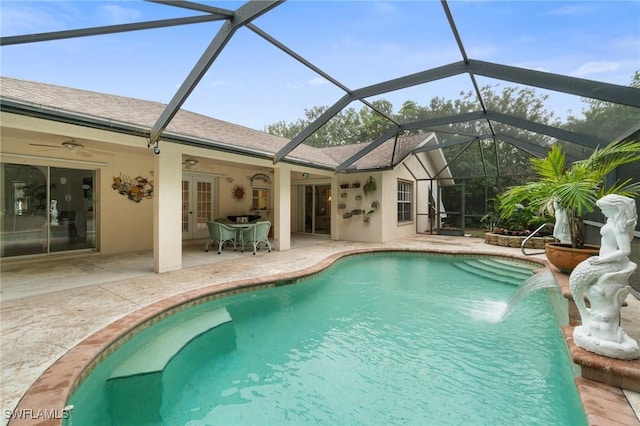 pool featuring ceiling fan, glass enclosure, french doors, and a patio area