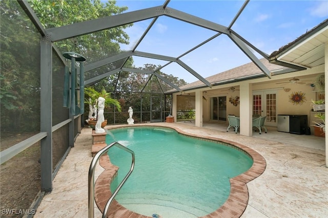 pool featuring a ceiling fan, glass enclosure, french doors, and a patio area