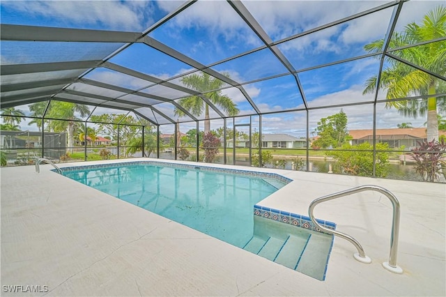 pool featuring a residential view, a patio area, glass enclosure, and a water view