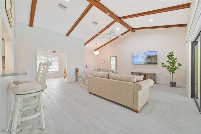 living room featuring visible vents, high vaulted ceiling, beam ceiling, and a ceiling fan