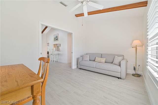 living room featuring beam ceiling, visible vents, wood tiled floor, ceiling fan, and baseboards