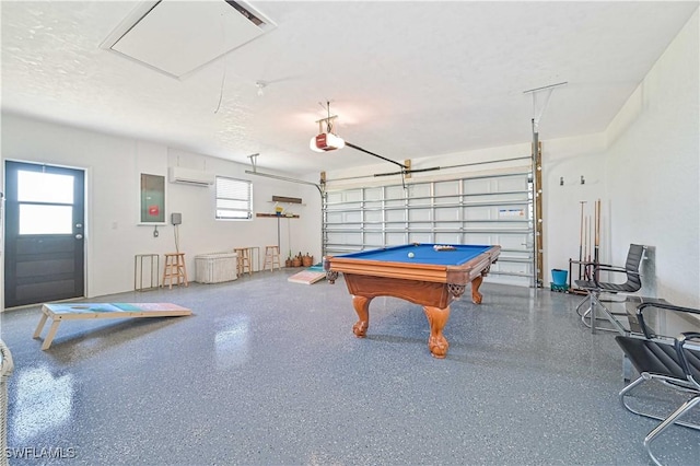 playroom with a garage, electric panel, a textured ceiling, and speckled floor