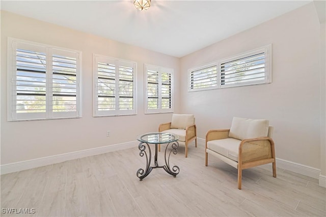 sitting room featuring light wood-type flooring and baseboards