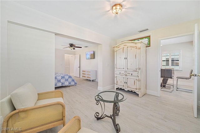 bedroom with light wood-style flooring, visible vents, and baseboards