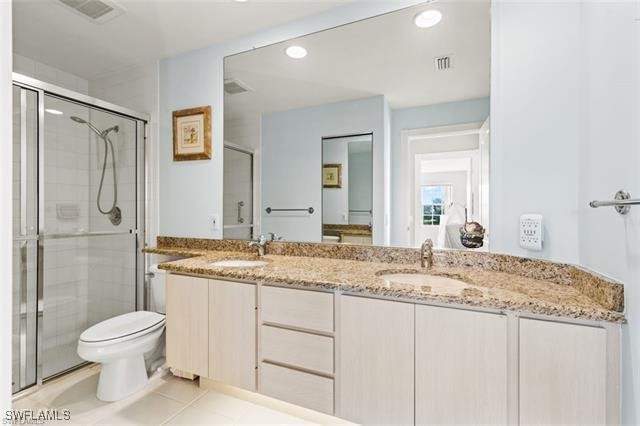 full bath with a sink, visible vents, and a shower stall