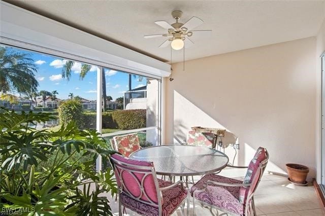 sunroom / solarium featuring ceiling fan