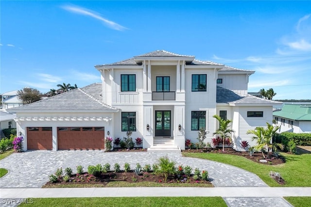 view of front facade with a garage and decorative driveway