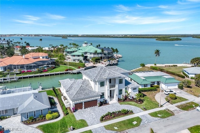 drone / aerial view featuring a residential view and a water view