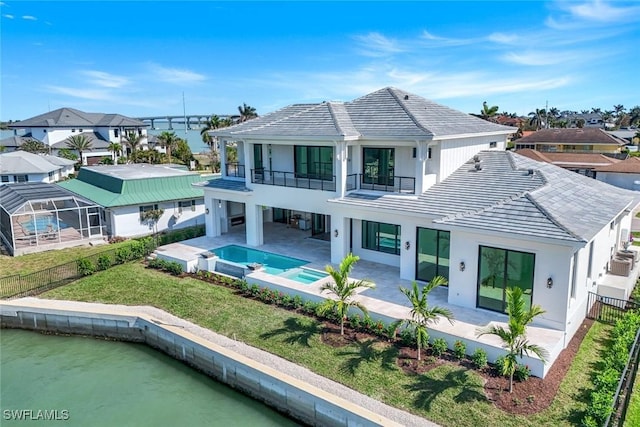 back of house featuring a patio area, fence, a balcony, and a water view