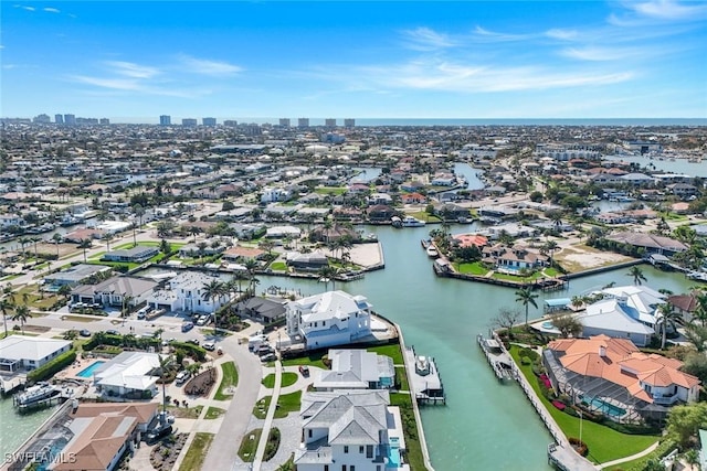 drone / aerial view with a water view, a view of city, and a residential view