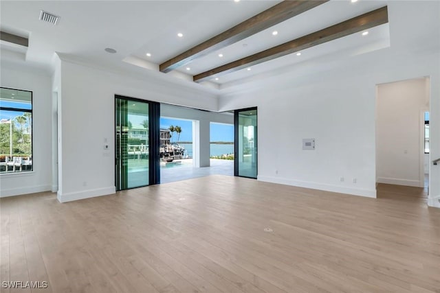 unfurnished living room featuring recessed lighting, visible vents, baseboards, light wood-type flooring, and beam ceiling