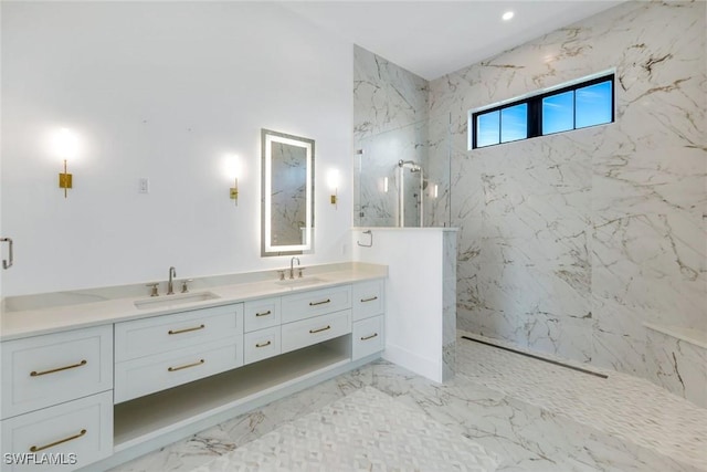 bathroom with double vanity, marble finish floor, and a sink