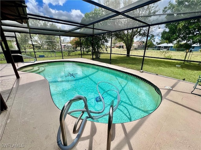 pool with glass enclosure, a lawn, and a patio