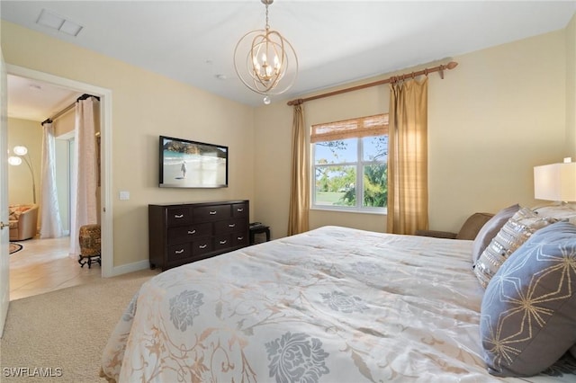 bedroom with carpet floors, a chandelier, visible vents, and baseboards