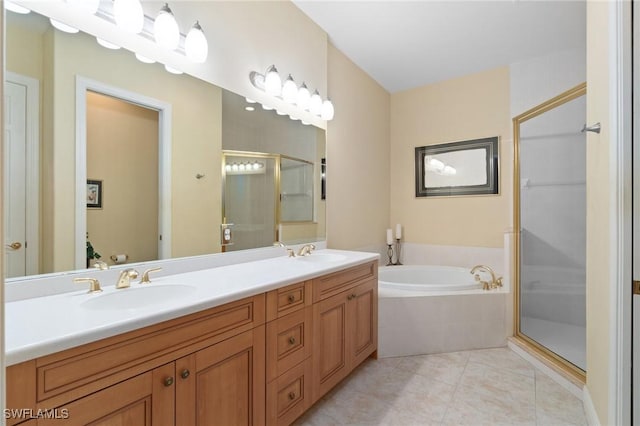 full bath with a stall shower, a garden tub, a sink, and tile patterned floors