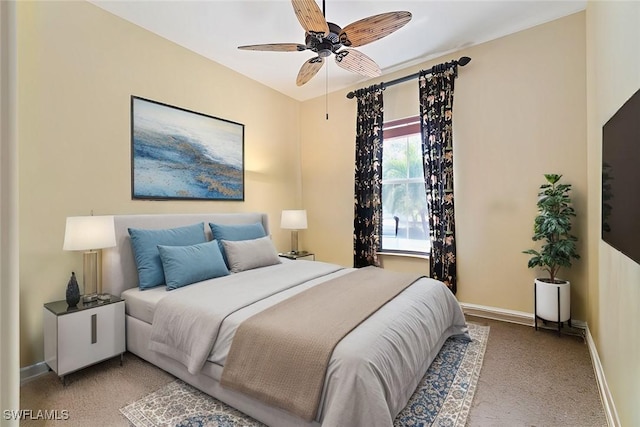 bedroom with ceiling fan and baseboards