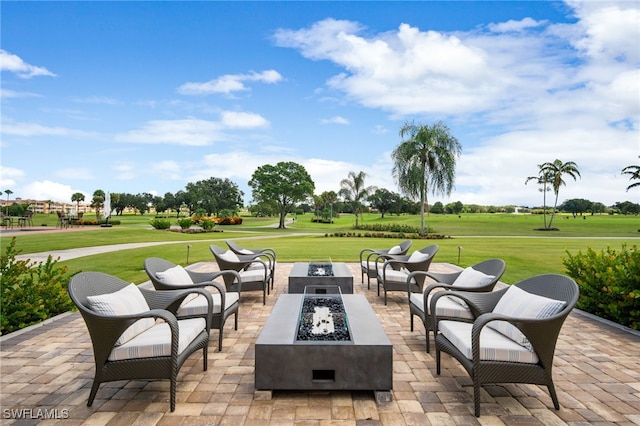 view of patio / terrace with an outdoor living space with a fire pit and golf course view