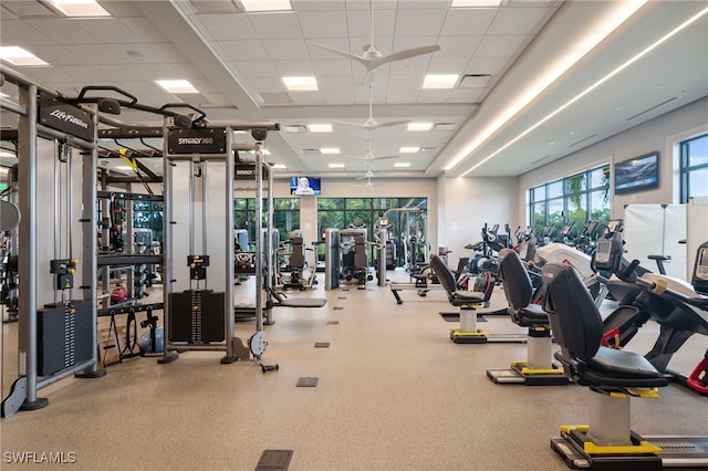 gym with a paneled ceiling